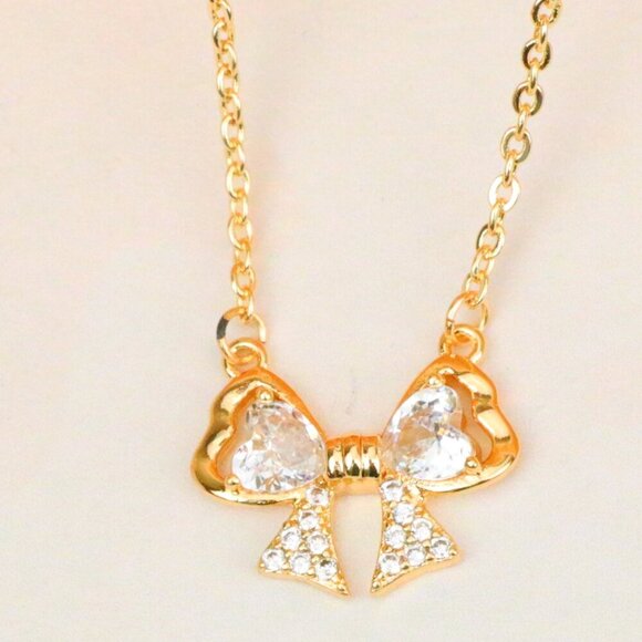 "Rose Gold Bow Necklace with Heart-Shaped Crystals and Pavé Detail, XPNL1888 - Picture 1 of 13